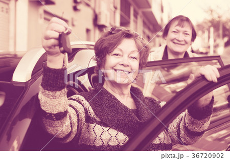 Woman with keys near car Woman with keys near car 36720902