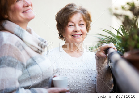 Women in pullovers on terrace Women in pullovers on terrace 36721010