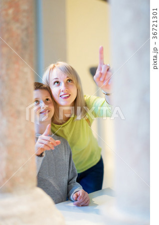 Mother and son regarding ancient statues 36721301