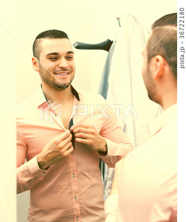 Man trying on new shirt 36722180