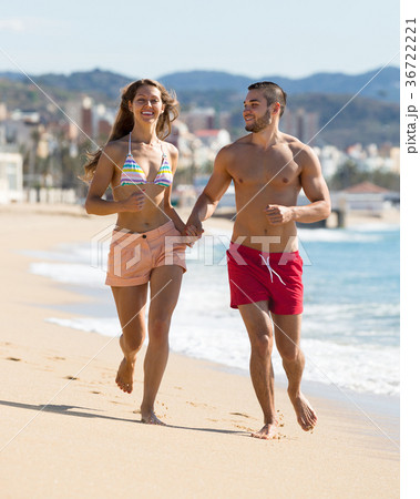 Young couple running near the sea 36722221