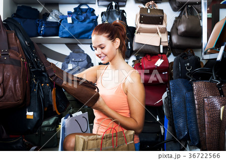 Girl buying handbag in fashion shop Girl buying handbag in fashion shop 36722566