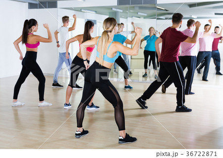 Smiling people dancing in dance school 36722871