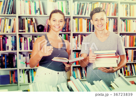 Teenagers buying new books and showing thumbs up Teenagers buying new books and showing thumbs up 36723839