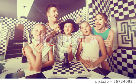 Family of five is satisfied of visit together of lost chessroom. Family of five is satisfied of visit together of lost chessroom. 36724092