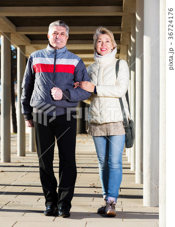 Mature couple walking outdoors Mature couple walking outdoors 36724176