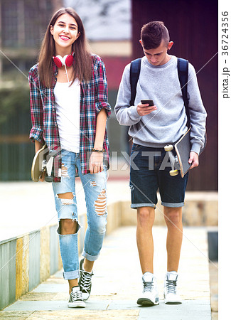 Teenagers with skateboards outdoors . 36724356