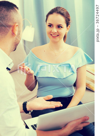 Man is talking with wife about project on sofa 36724497