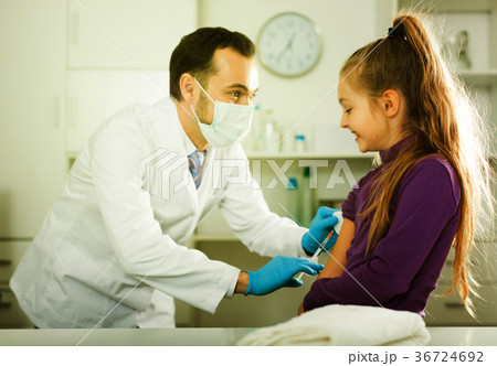 Male doctor injecting little patient Male doctor injecting little patient 36724692