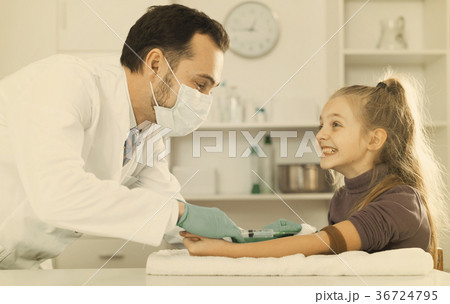 Male doctor injecting little patient Male doctor injecting little patient 36724795