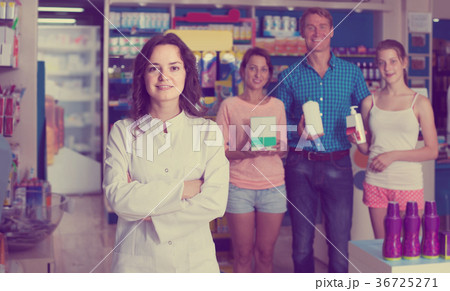 portrait of female druggist in white coat working in pharmacy 36725271