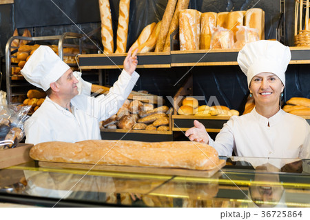 Portrait of cheerful bakers with fresh bread smiling 36725864