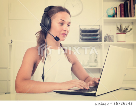 young woman with head set at office. young woman with head set at office. 36726543