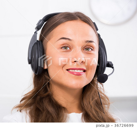 portrait of female operator with headset on answering at call center portrait of female operator with headset on answering at call center 36726699