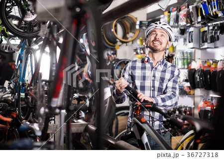 Man picks up a modern sports bike 36727318