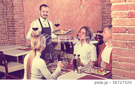 Male waiter bringing order to visitors Male waiter bringing order to visitors 36727320