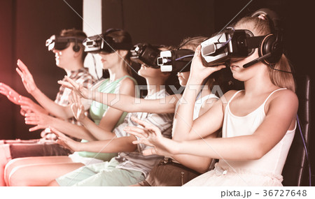 Young girl is enjoying virtual reality in glasses Young girl is enjoying virtual reality in glasses 36727648
