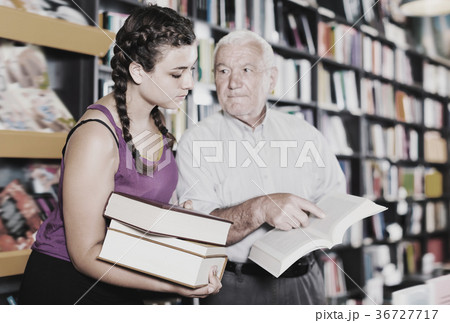 Joyful grandfather with girl are reading books 36727717
