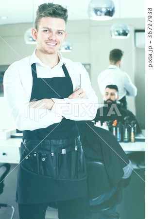 Young guy displaying his workplace at hairdressing salon 36727938