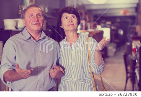 woman with her husband are buying furniture in antique store 36727950