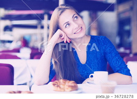 Young woman is dreaming in time breakfast Young woman is dreaming in time breakfast 36728278