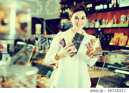 Woman choosing chocolate bar Woman choosing chocolate bar 36728327