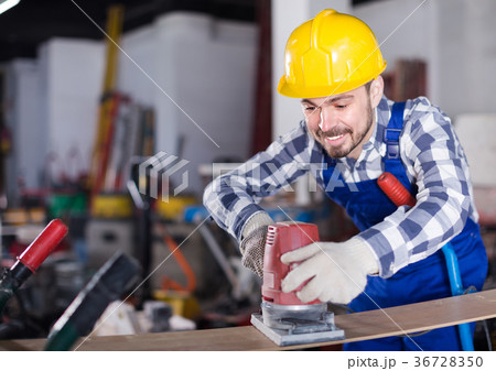 Young man is using grinder for construction work Young man is using grinder for construction work 36728350