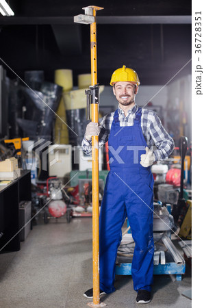 Young positive man worker assembling framing 36728351