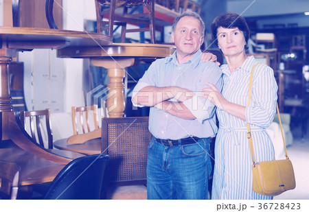 Smiling couple is shopping the old table Smiling couple is shopping the old table 36728423