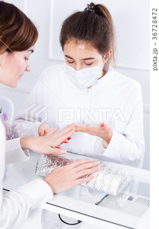 Woman doing shellac manicure Woman doing shellac manicure 36728472