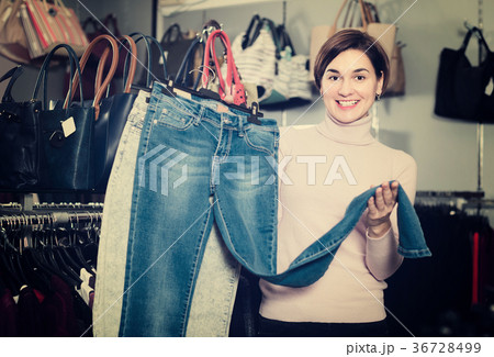 Young female customer is choosing new jeans 36728499