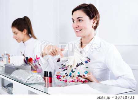 Manicurist demonstrating nail polish 36728731