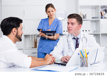 Doctor listening to patient complaints at clinic Doctor listening to patient complaints at clinic 36728826