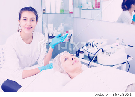 Woman making beauty procedures for face Woman making beauty procedures for face 36728951