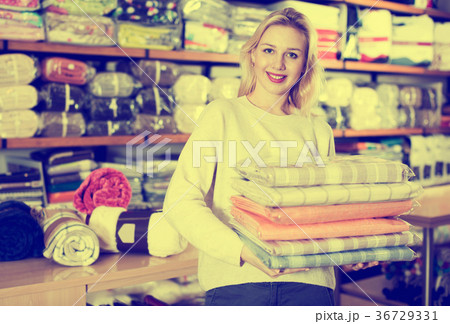 Woman enjoying purchased home textiles Woman enjoying purchased home textiles 36729331