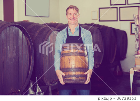 Man carrying wine wood in hands Man carrying wine wood in hands 36729353