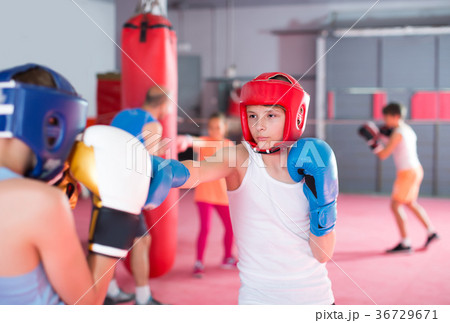 Cheerful boys and girl practicing boxing punches 36729671