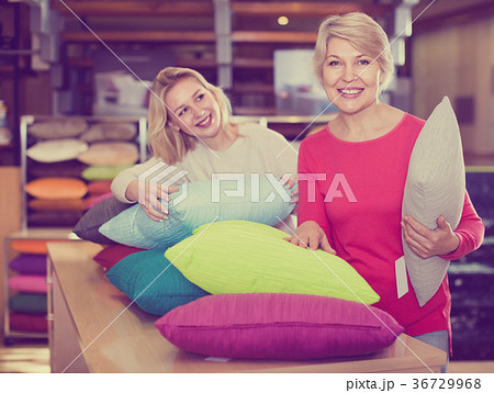 Young girl and aged mother choosing pillows 36729968
