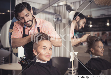 Man hairdresser making hairstyle for woman Man hairdresser making hairstyle for woman 36730020