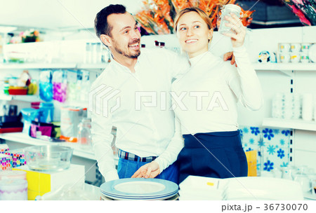Couple choosing new crockery in dinnerware store 36730070