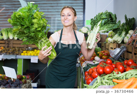 Seller holding fresh celery and mangold 36730466