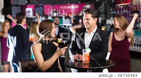 Colleagues dancing on corporate party with cocktails in hands Colleagues dancing on corporate party with cocktails in hands 36730483