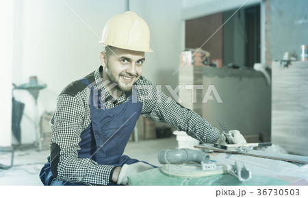 Male worker is preparing for repair in the room Male worker is preparing for repair in the room 36730503
