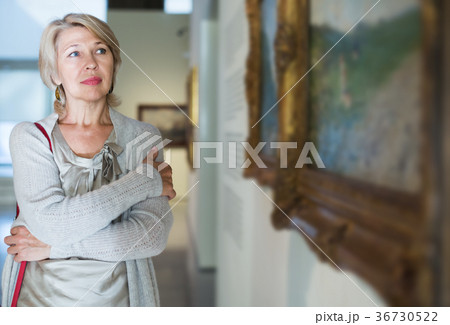 Woman looking at picture collection 36730522