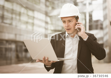 Cheerful male talking about work at the laptop 36730546