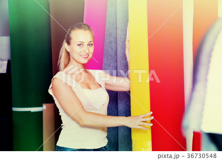 Cheerful woman customer shopping carpet flooring 36730548