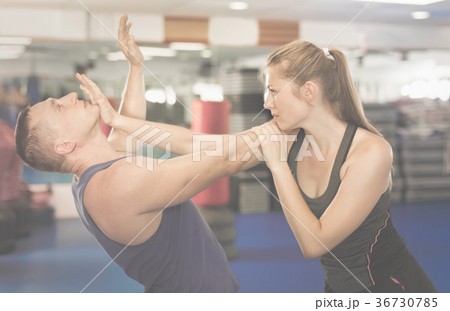 Young woman and her trainer are practicing captures Young woman and her trainer are practicing captures 36730785