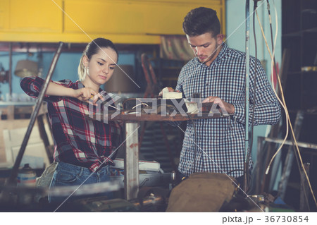 engineers working together in workshop 36730854