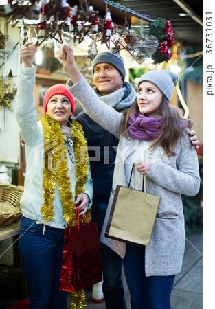 family of three with teenage girl choosing floral decorations at market. Shallow depth of focus 36731031