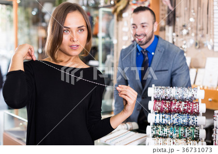 woman choosing chainlet and pendants 36731073